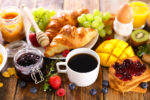 continental breakfast with coffee cup, fruit and croissant